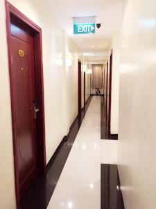 a corridor of an office building with a sign that reads exit at De Best Hotel in Nagoya