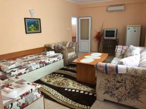 a living room with two couches and a table at Daniel Guest House in Nesebar