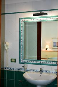a bathroom with a sink and a mirror at Hotel Amyclae in Sperlonga