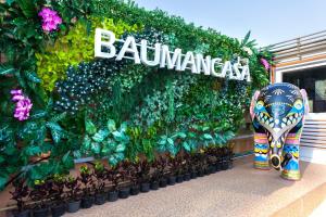 an elephant in front of a wall of plants at Baumancasa Beach Resort in Karon Beach