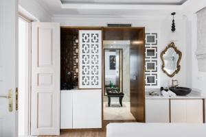 a bathroom with white cabinets and a mirror at La Canea Canvas 1 in Chania +24 photos