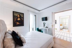 a white bedroom with a large white bed in a room at La Canea Canvas 1 in Chania