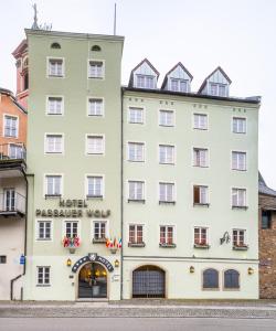 
a building with a clock on the front of it at Hotel Passauer Wolf in Passau
