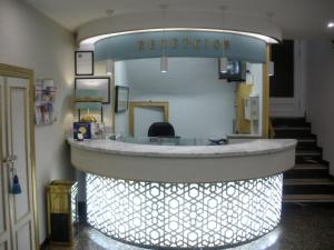 a lobby with a reception counter in a building at Hotel Sacromonte in Granada