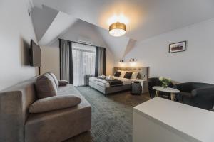 a living room with a couch and a bed at Willa Feria in Międzyzdroje