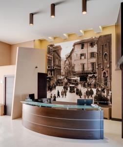 a lobby with a black and white photo of a street at Stadio Hotel in Piacenza