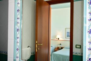 a door leading to a bedroom with a bed at Hotel Amyclae in Sperlonga