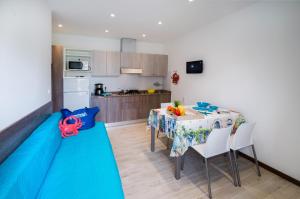 a kitchen and dining room with a table and chairs at Villaggio Michelangelo in Bibione