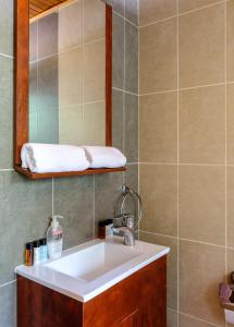 a bathroom with a sink and a mirror at Platres Valley Houses in Platres
