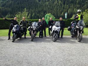a group of men on motorcycles posing for a picture at Wohlfühlpension Kreischberg in Sankt Georgen ob Murau