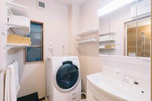 a washing machine in a bathroom next to a sink at Miro Sanjo Saiin Tei in Kyoto +13 photos