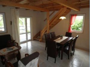 a living room with a dining room table and chairs at Apartamenty Beata Wisełka in Wisełka