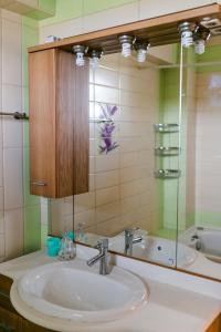 a bathroom with a sink and a mirror at Villa Polina in Skala Potamias