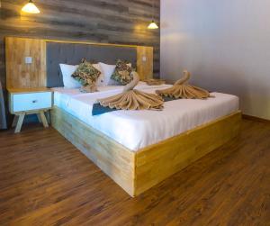 a bedroom with two beds with towels on them at Sara Resort in Koh Rong Sanloem