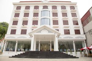 a white building with stairs in front of it at Windsor Hotel Son La in Sơn La