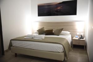 Postel nebo postele na pokoji v ubytování Hotel Belsito