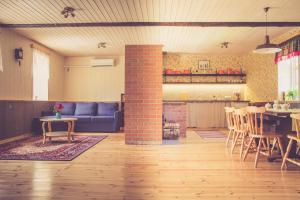 a living room with a couch and a table and a fireplace at Palade Retrovisiit Leili in Palade
