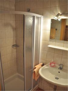 a bathroom with a shower and a sink at Hiaslahof in Mariapfarr +32 photos