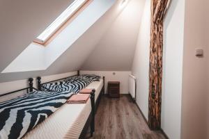 two beds in a room with a attic at Villa u Arény in Ostrava