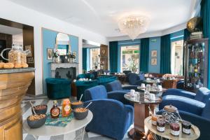 a restaurant with blue chairs and a fireplace at The Jay Hotel by HappyCulture in Nice