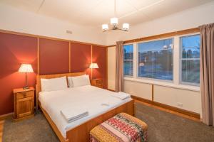 a bedroom with a large bed and a window at Tarraleah Estate in Tarraleah