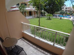 a balcony with a table and a view of a park at Kalias Hotel in Vasiliki