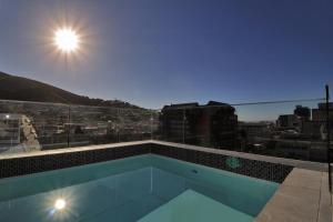 a swimming pool with a view of a city at Sensational Sentinel in Cape Town