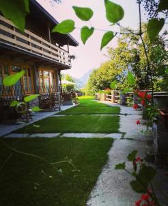 a walkway next to a house with a yard at Agriturismo La Selvaggia in Mandello del Lario