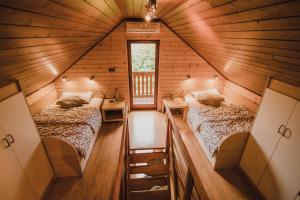 a room with two beds in a log cabin at Lazec Country House in Plužnje