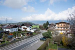 a view of a town with houses and a street at Pension Post - Sistrans in Innsbruck