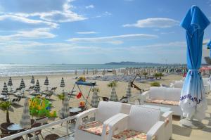 a view of a beach with chairs and umbrellas at EKA Luxury One-Bedroom Apartment in Durrës