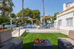 a bowl of fruit on a table in a yard at Villa Sol in Alcudia