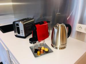 a kitchen counter with a coffee maker and a toaster at Les Mille et une Nuits in Rouen
