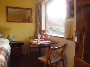a room with a table with two chairs and a window at The Cabins Conwy in Conwy