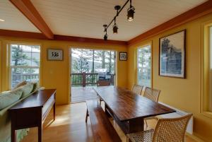 a dining room with a wooden table and chairs at Shore Thing Retreat in Eastsound