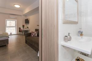 a bathroom with a sink and a couch in a room at Luxury Rooms Saint Jacob in Trogir