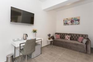 a living room with a couch and a table at Luxury Rooms Saint Jacob in Trogir