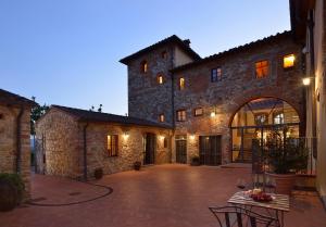 a large stone building with a patio in front of it at Borgo Antico Casalbosco Holiday Home & Winery in Santomato 