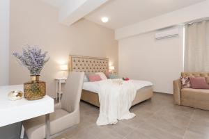 a bedroom with a bed and a table and a couch at Luxury Rooms Saint Jacob in Trogir +113 photos