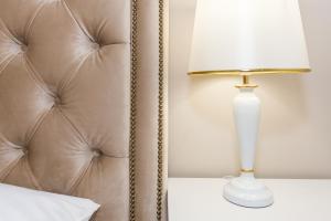 een bed met een witte lamp naast een bank bij Luxury Rooms Saint Jacob in Trogir