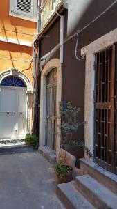 a building with a door and stairs next to a building at Il Pozzo di Santa Teresa in Catania