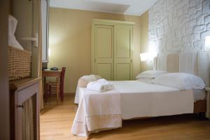 Postel nebo postele na pokoji v ubytování Hotel & Terme Bagni di Lucca
