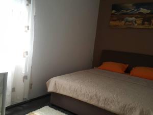 a bedroom with a bed and a painting of horses on the wall at Apartment Djordje Budva-Jaz in Kukaljevina