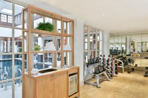a gym with a lot of treadmills and exercise equipment at The Savoy in London