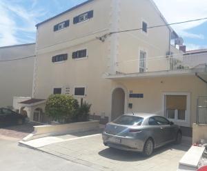 a car parked in front of a building at Apartment GoodMood in Split