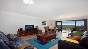 a living room with a couch and a table at Kingscliff Waters Apartment 5 in Kingscliff
