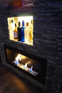 a fireplace with some bottles of alcohol in it at California Beach Lounge - Słoneczne Tarasy w Porta Mare, Dziwnowek in Dziwnówek