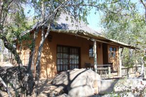 una casa en medio de un bosque en Tantebane Game Ranch, en Tantebane