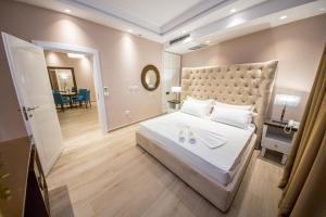 a bedroom with a large bed with a large headboard at Sole Luna Hotel in Borsh