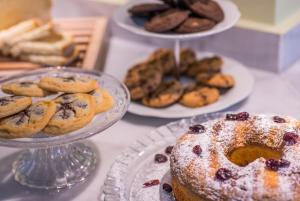a table with plates of pastries and plates of bread at Mirabilia Boutique Hotel in Kriopigi
